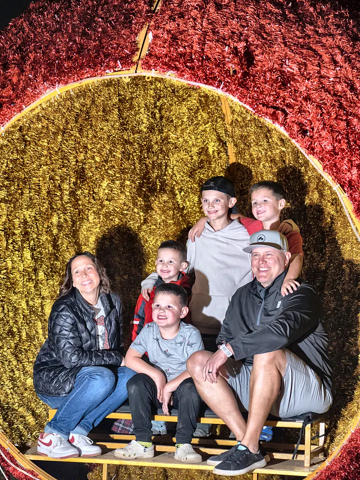 A family squeezed into a giant gold ornament