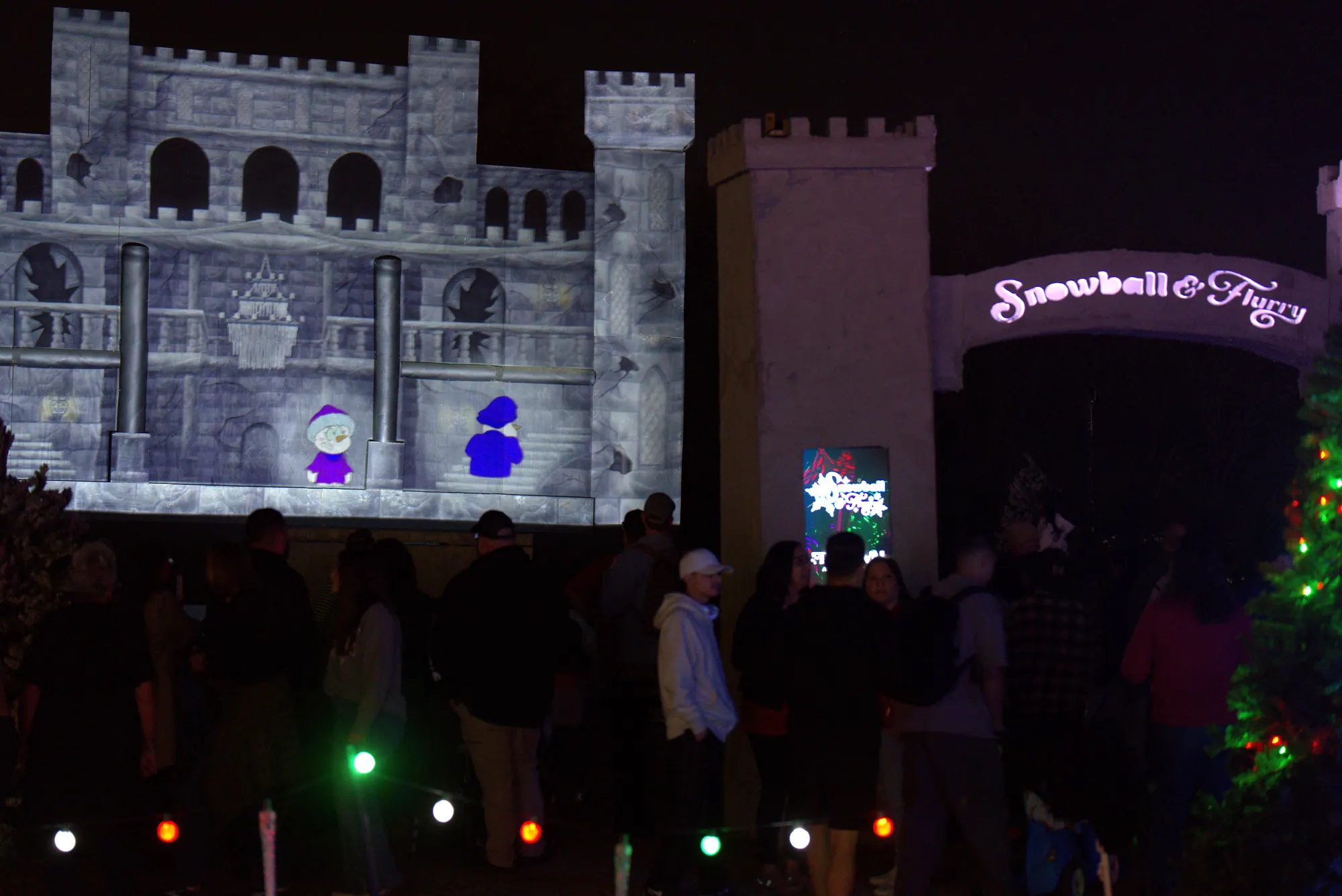 Snowball and Flurry, two snowman characters, projected on the castle during the show